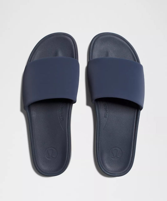 Pair of navy blue slides on a light gray background