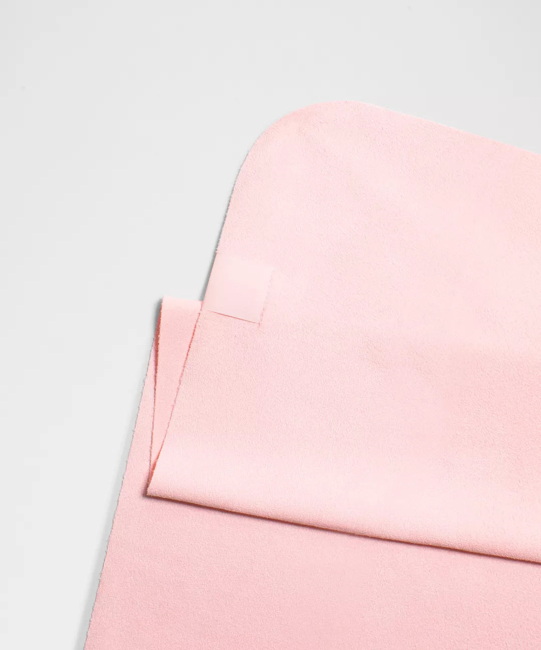 Close-up of a pink fabric texture on a light gray background