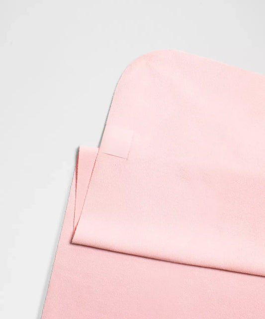 Close-up of a pink fabric texture on a light gray background