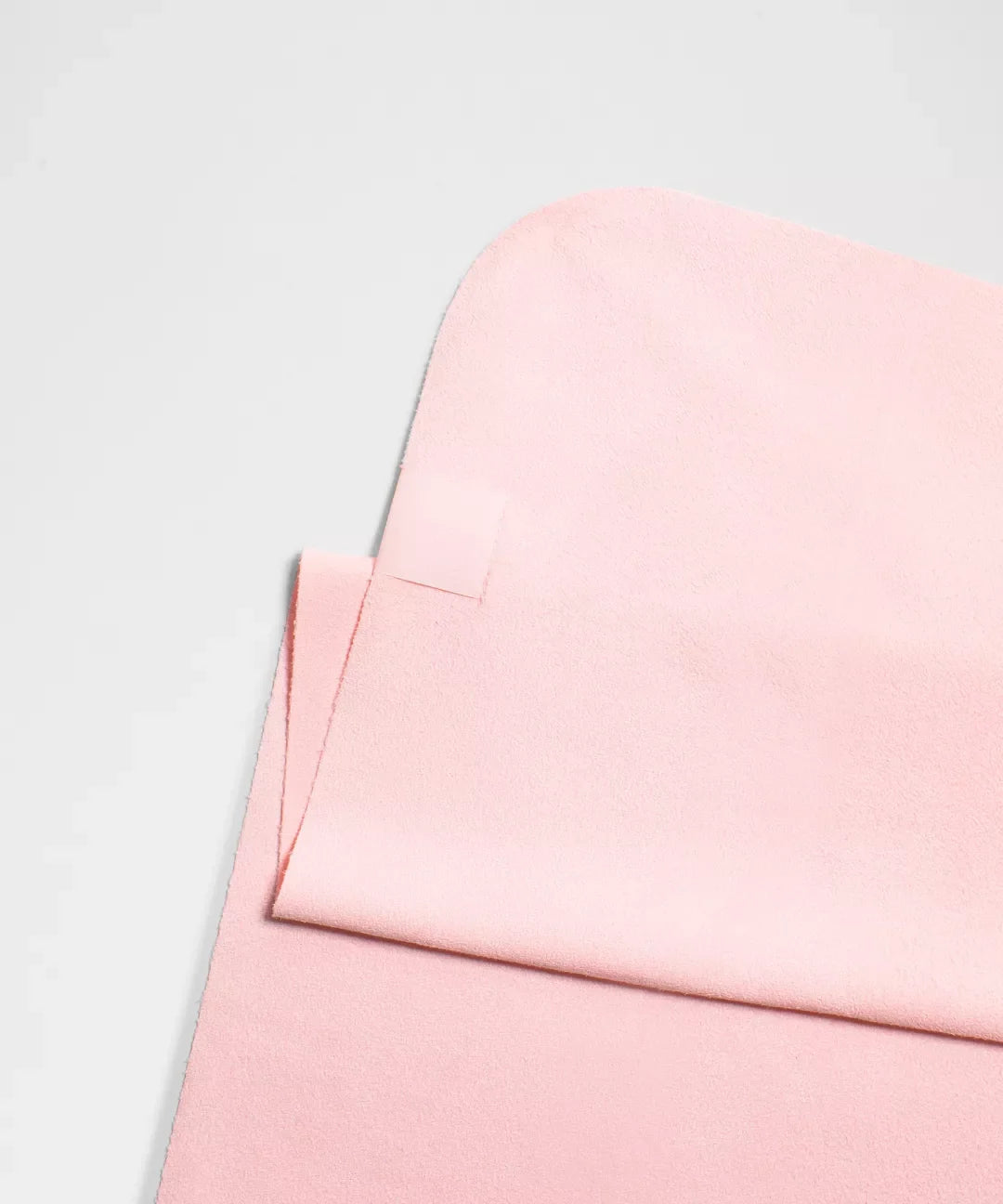 Close-up of a pink fabric texture on a light gray background