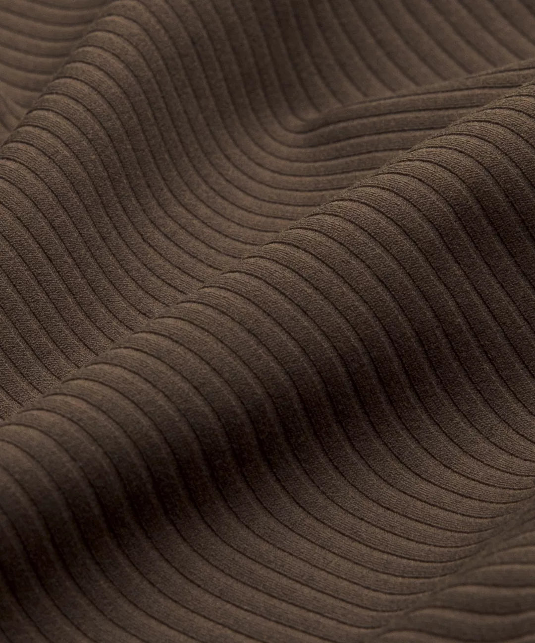 Close-up of brown textured fabric with wavy pattern