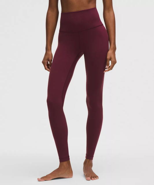 Maroon leggings worn by a person on a white background