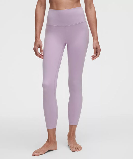 Person wearing light purple leggings on a white background