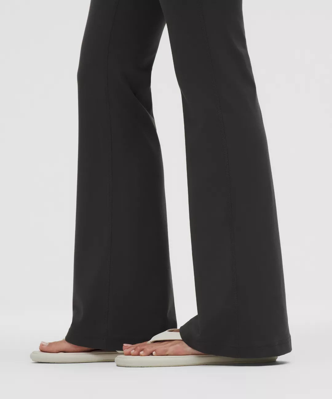 Black wide-leg pants worn by a person on a white background