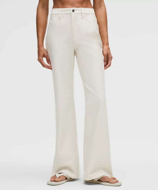 Person wearing white wide-leg pants on a plain background