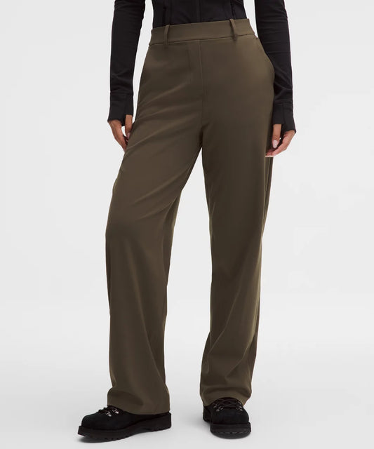 Brown pants worn by a person on a white background