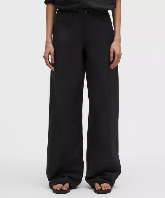 Black wide-leg pants worn by a person on a white background