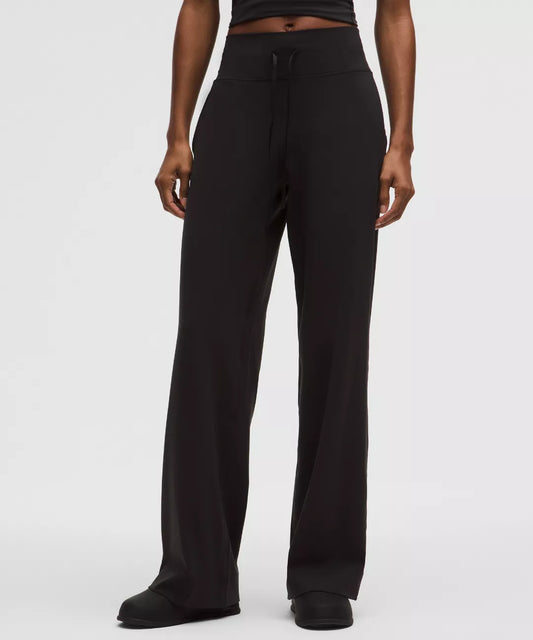 Black pants worn by a person on a white background