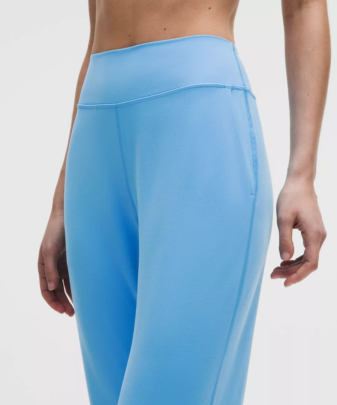 Light blue leggings worn by a person on a white background
