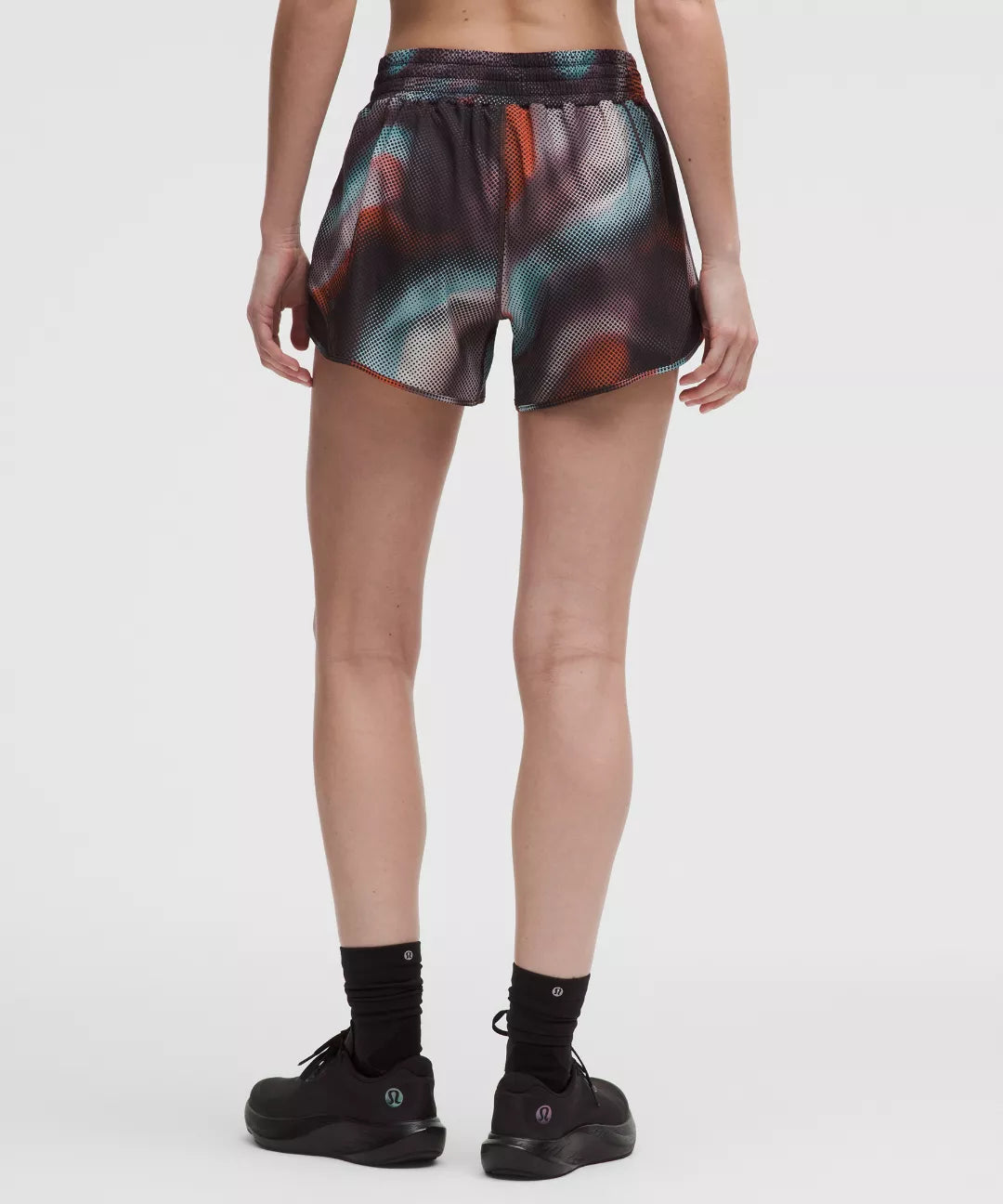 Person wearing colorful shorts on a white background