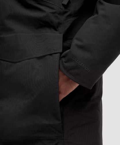 Close-up of a black jacket with 'C.P. Company' branding on a light gray background
