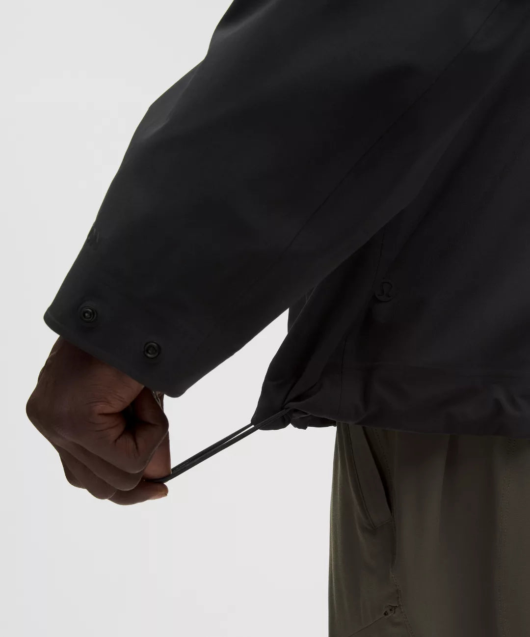 Person wearing a black coat with a white background