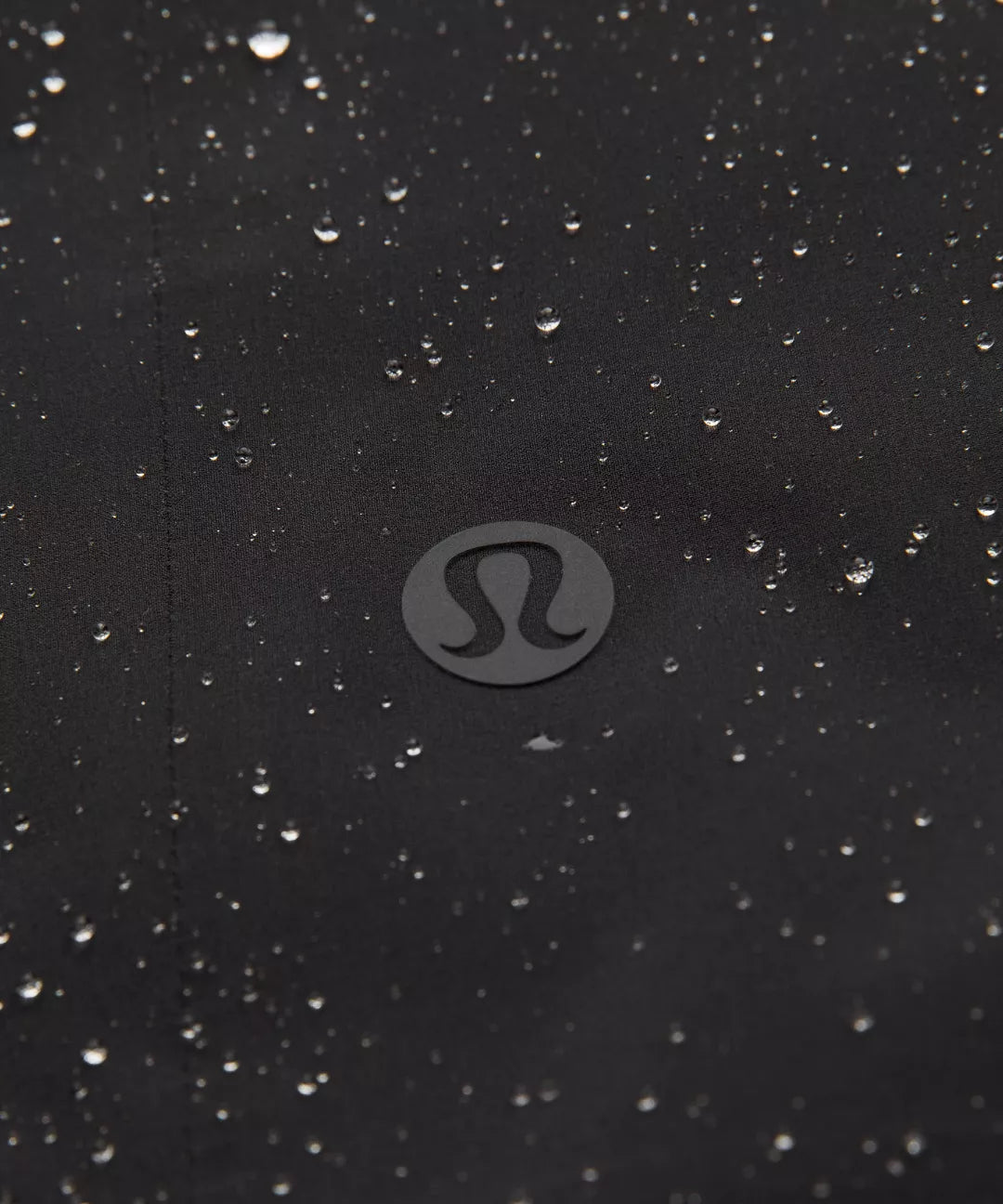 Black surface with water droplets and a visible brand logo.