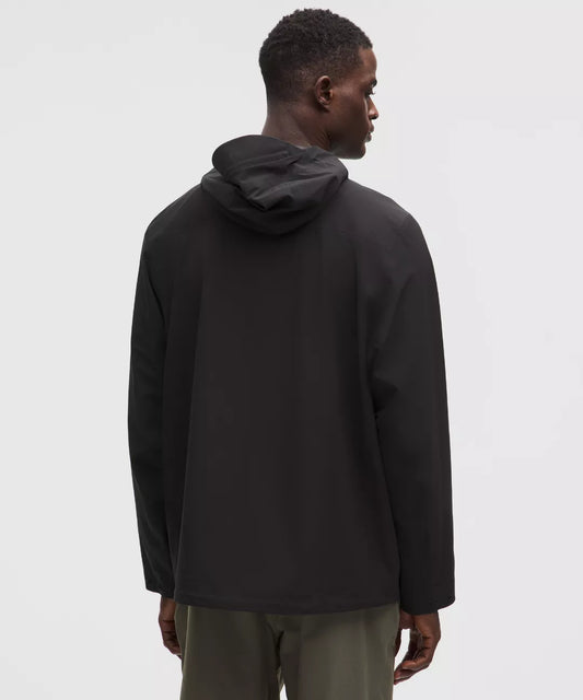Person wearing a black hoodie from behind on a white background
