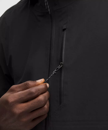 Close-up of a person zipping up a black jacket