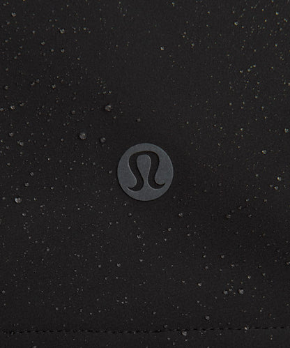 Close-up of a black textured surface with a Lululemon logo in the center.