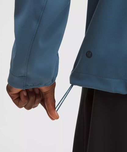 Close-up of a person wearing a blue jacket with a white background