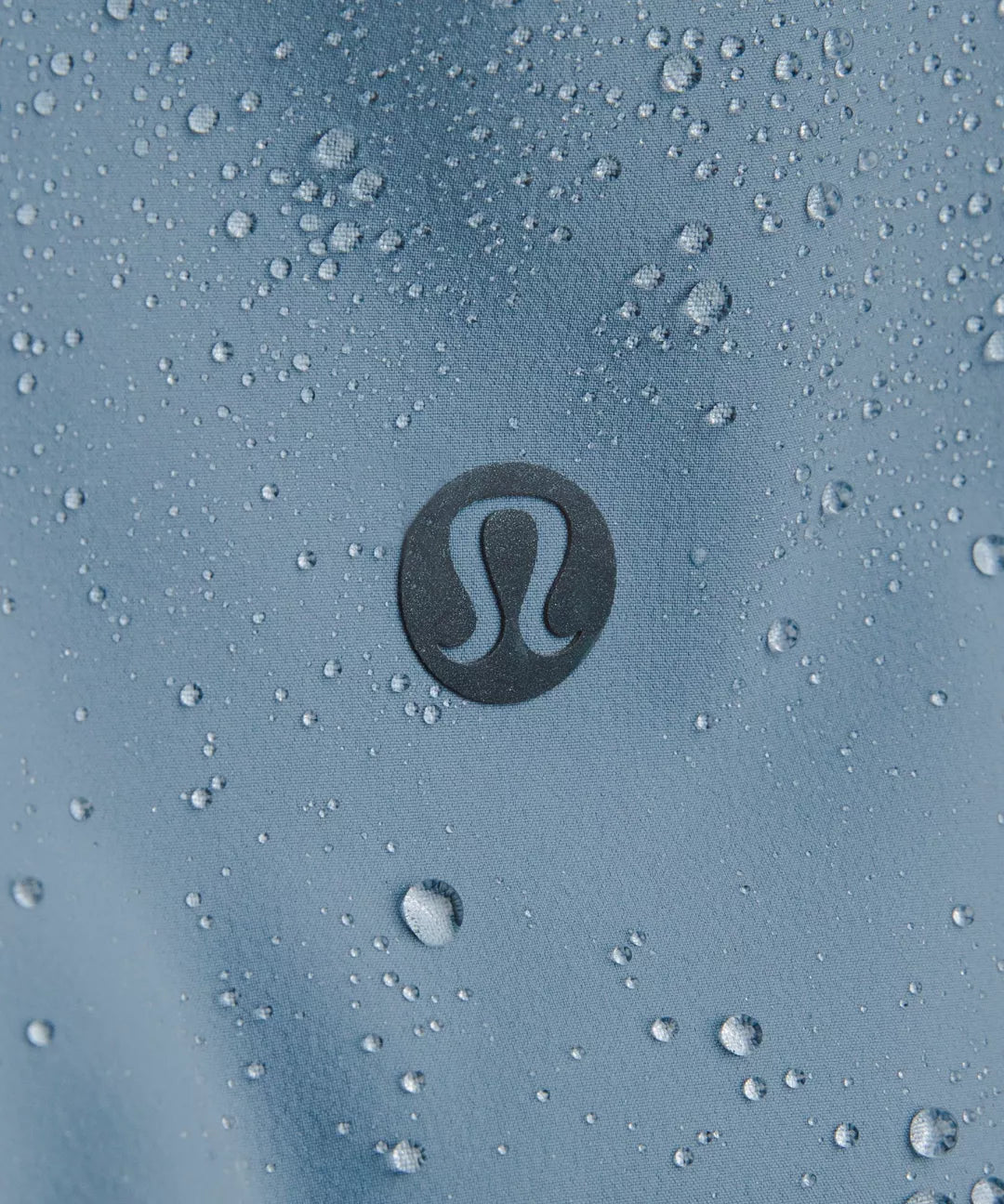 Lululemon logo on a textured blue surface with water droplets