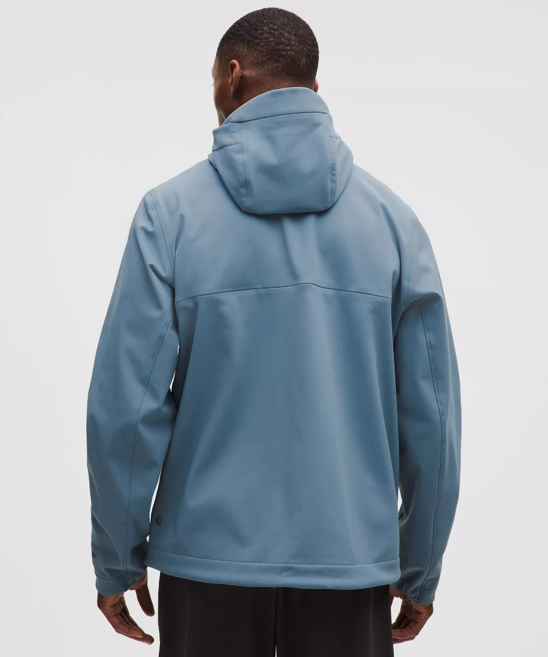Person wearing a blue jacket on a light gray background