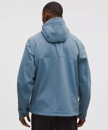 Person wearing a blue jacket on a light gray background