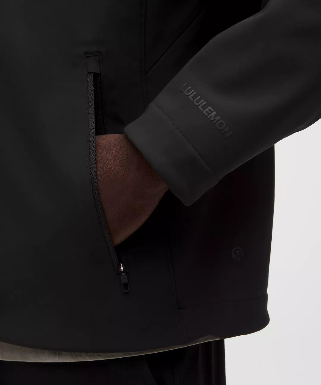Black jacket with a visible brand logo on a light gray background