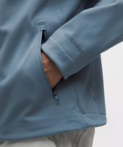 Close-up of a blue jacket with a brand logo on a white background