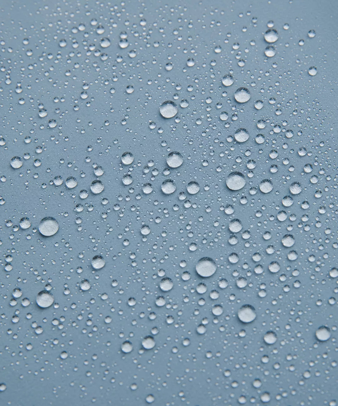 Water droplets on a blue glass surface