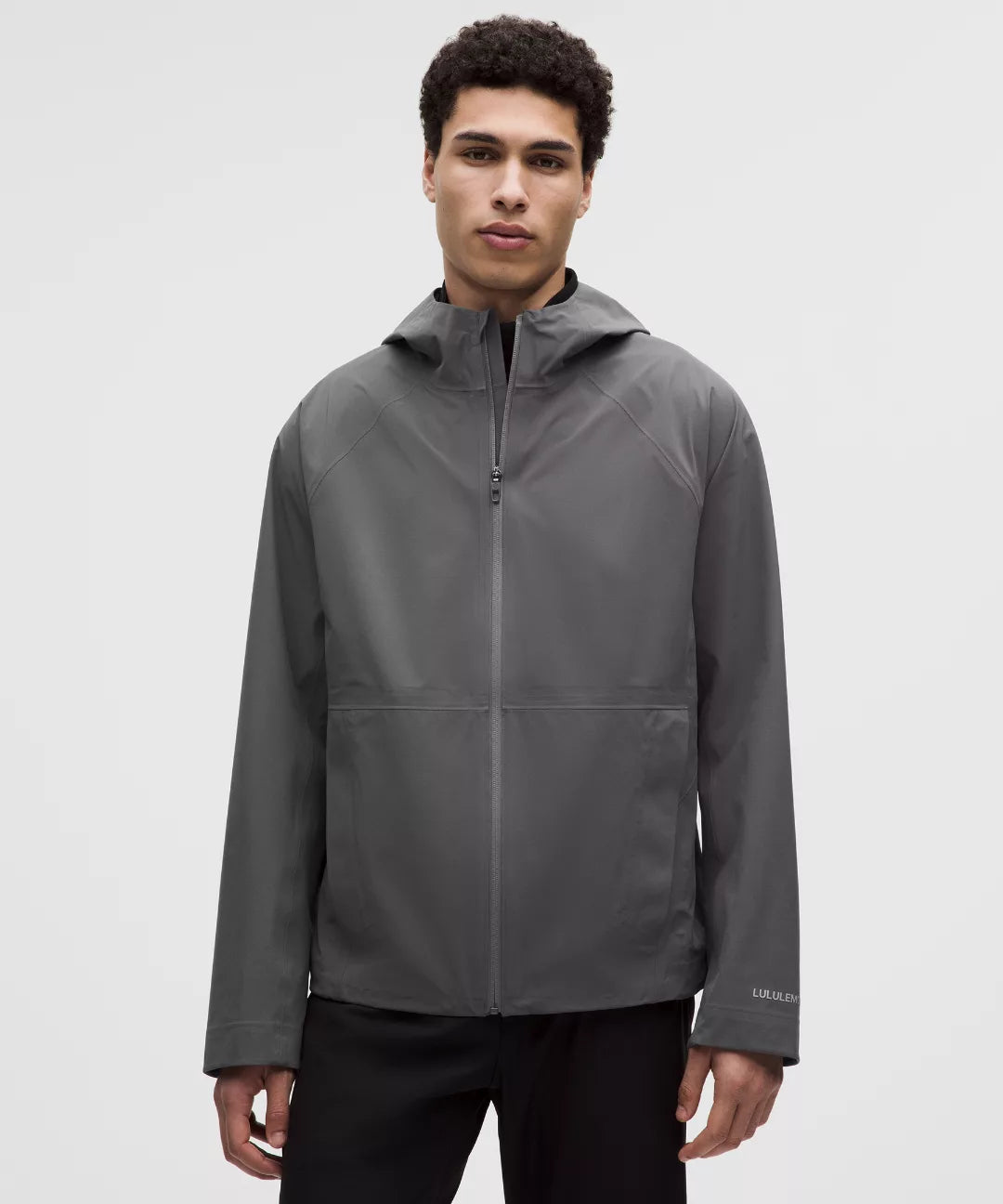 Man wearing a gray jacket on a white background