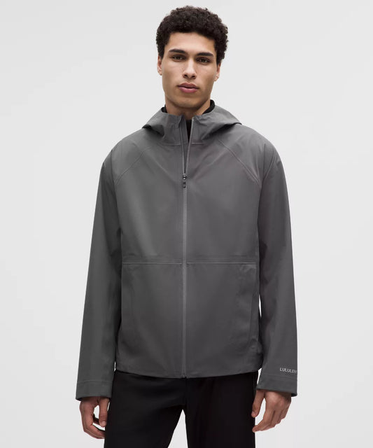 Man wearing a gray jacket on a white background