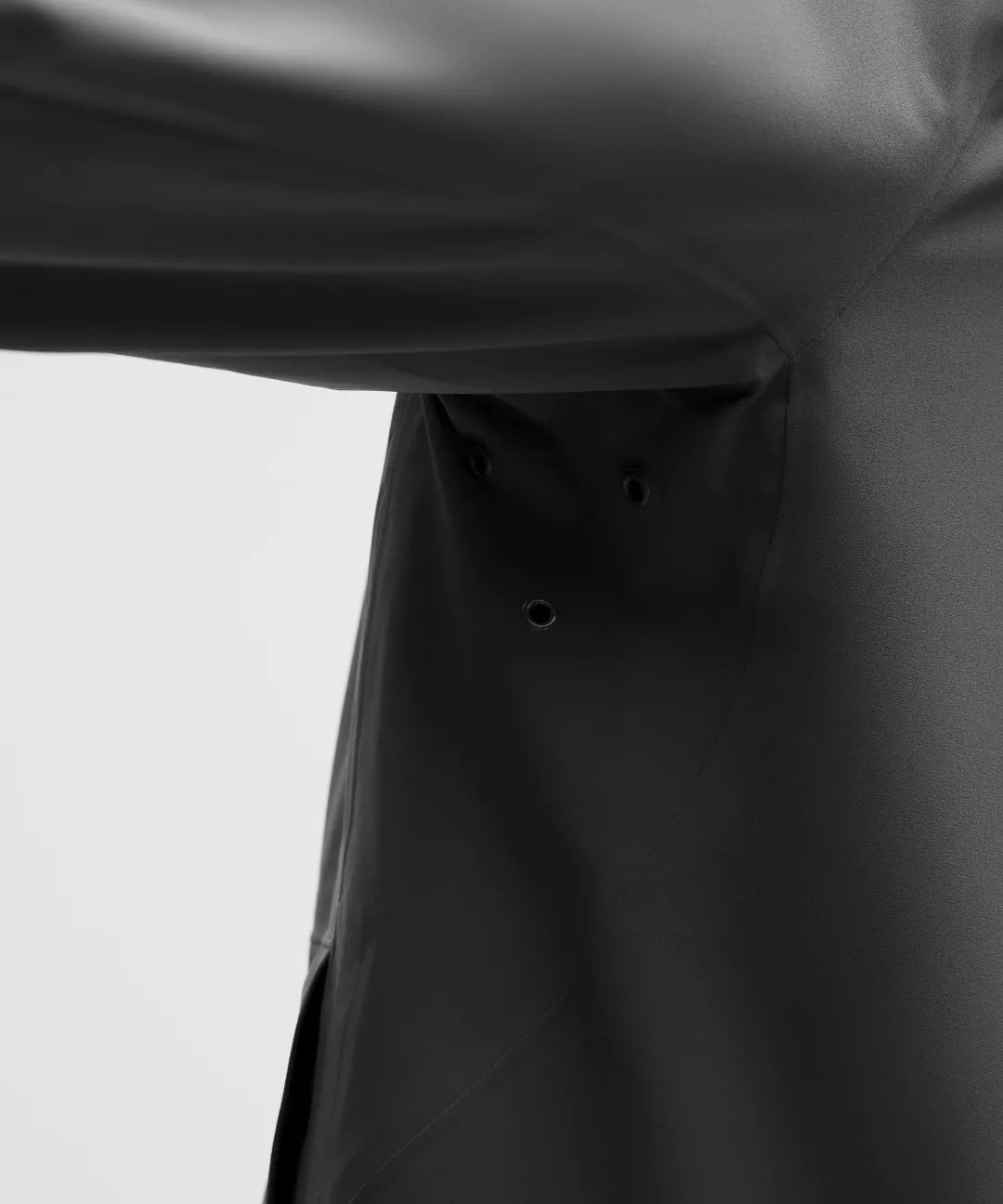 Close-up of a black raincoat on a white background