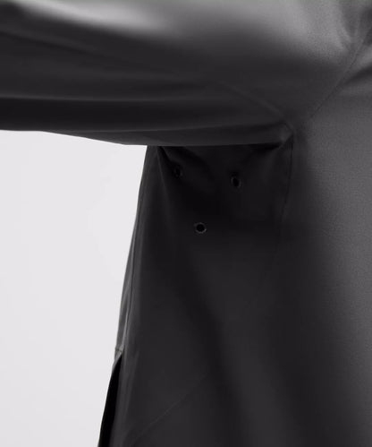 Close-up of a black raincoat on a white background