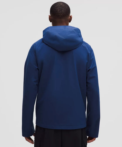 Person wearing a blue hooded jacket on a light gray background