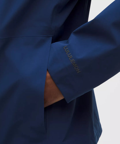 Navy blue athletic jacket with 'Lululemon' branding on a light gray background