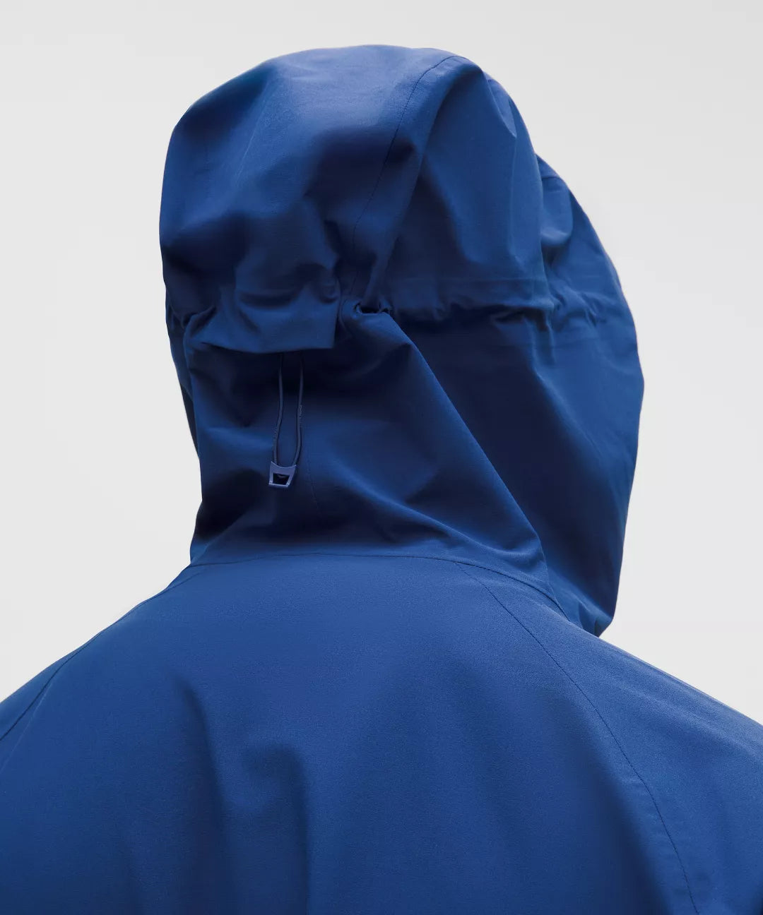 Blue raincoat with a hood on a light gray background