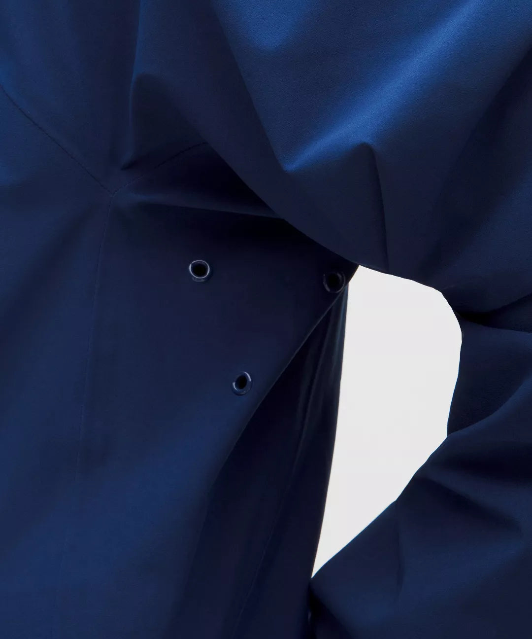 Close-up of a dark blue fabric texture with a light gray background