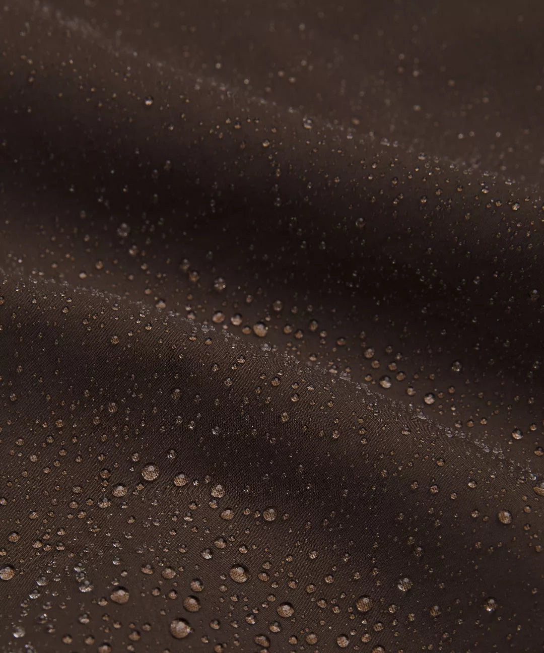 Close-up of water droplets on a dark surface