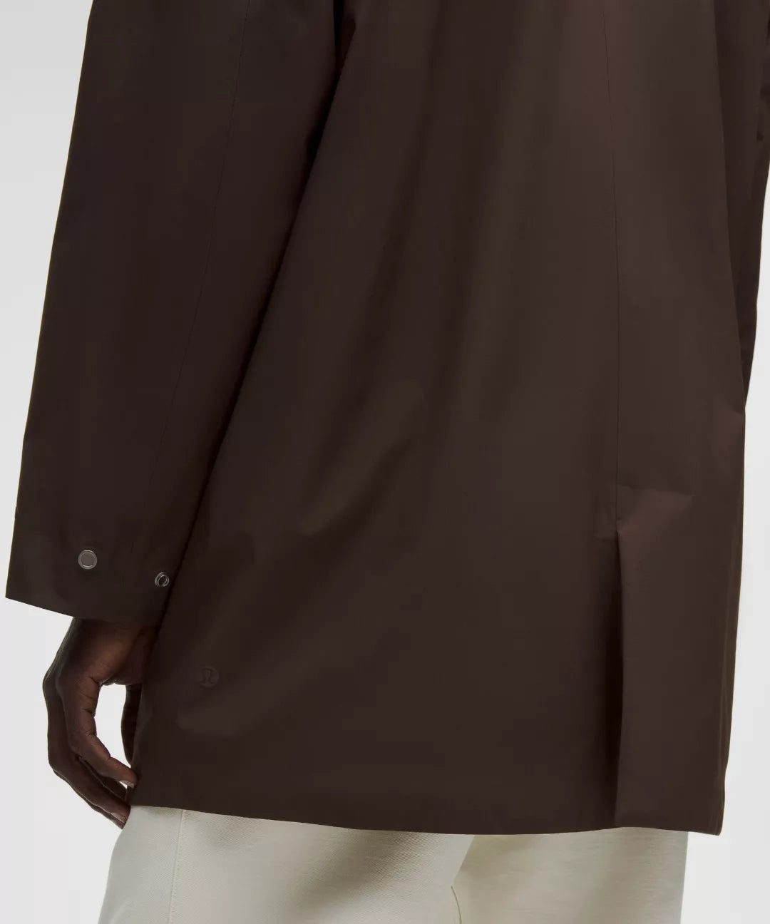 Brown jacket worn by a person on a white background