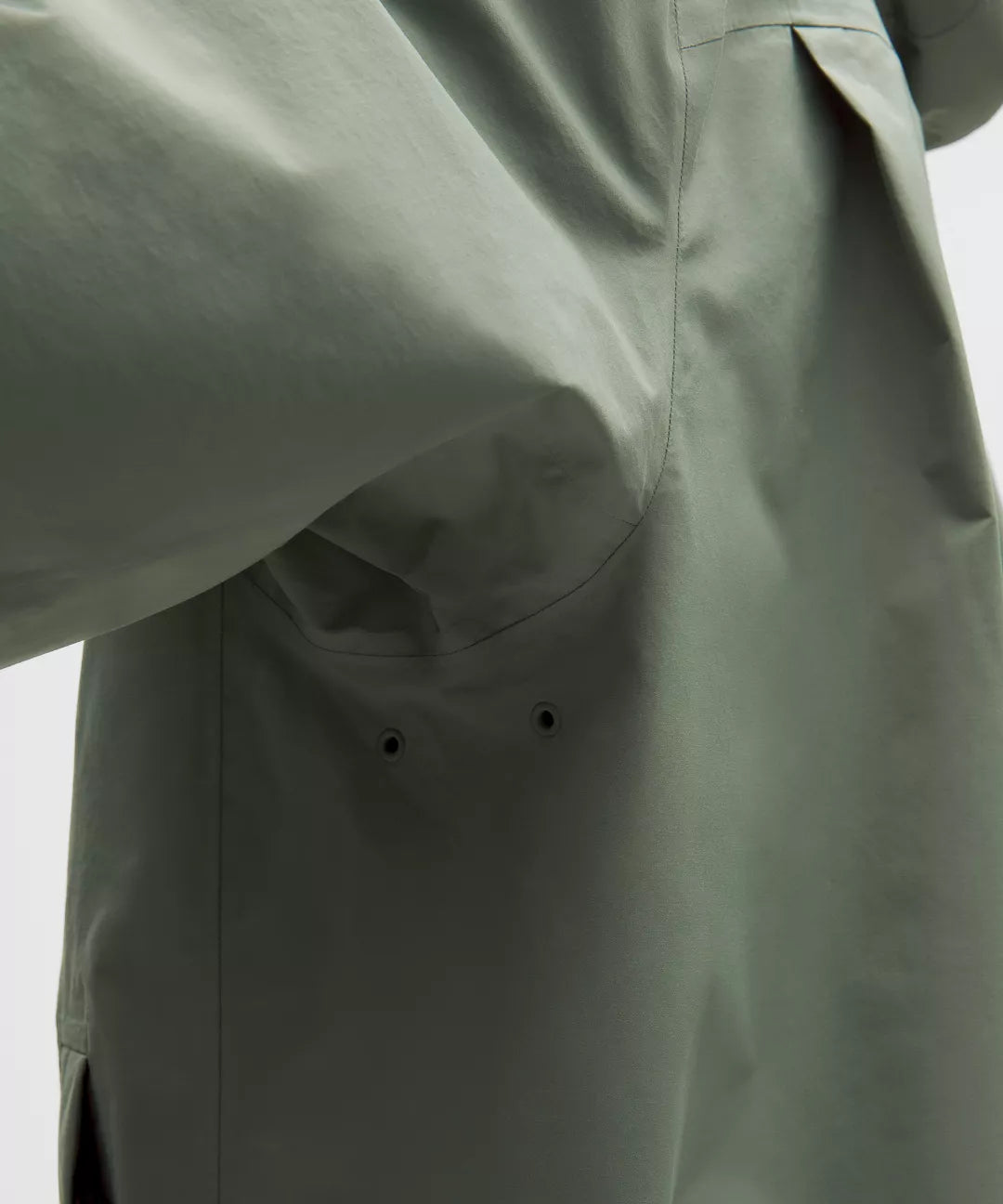 Green jacket with a focus on the fabric texture and design.