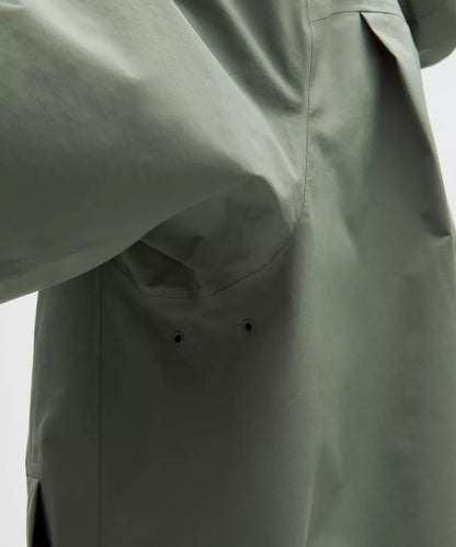 Green jacket with a focus on the fabric texture and design.
