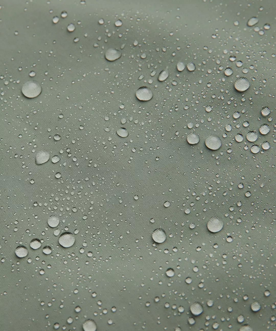 Water droplets on a greenish surface