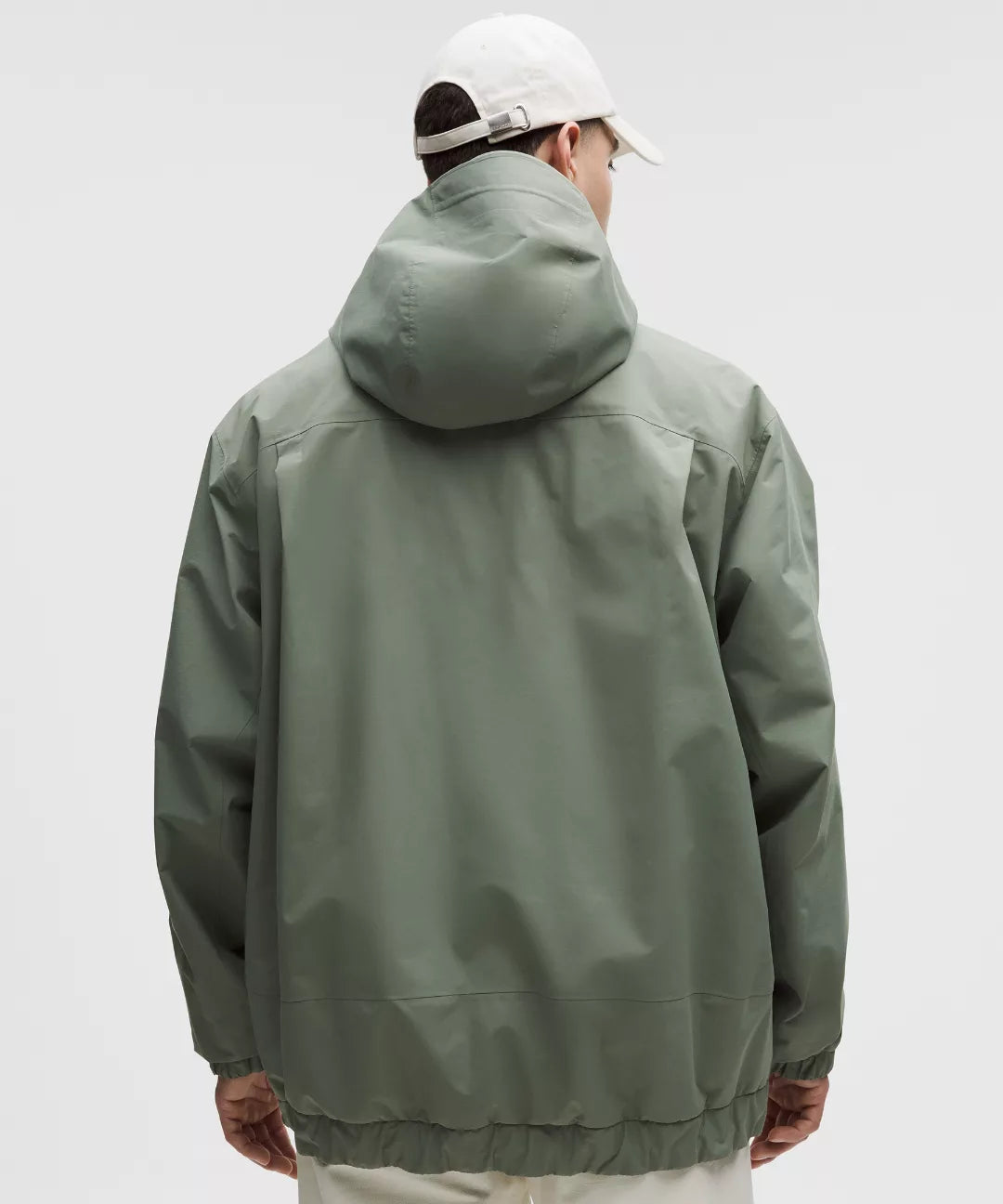 Person wearing a green jacket with a hood on a white background