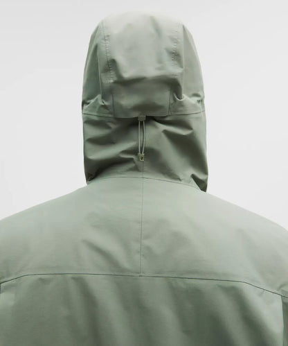 Green raincoat with a hood on a white background