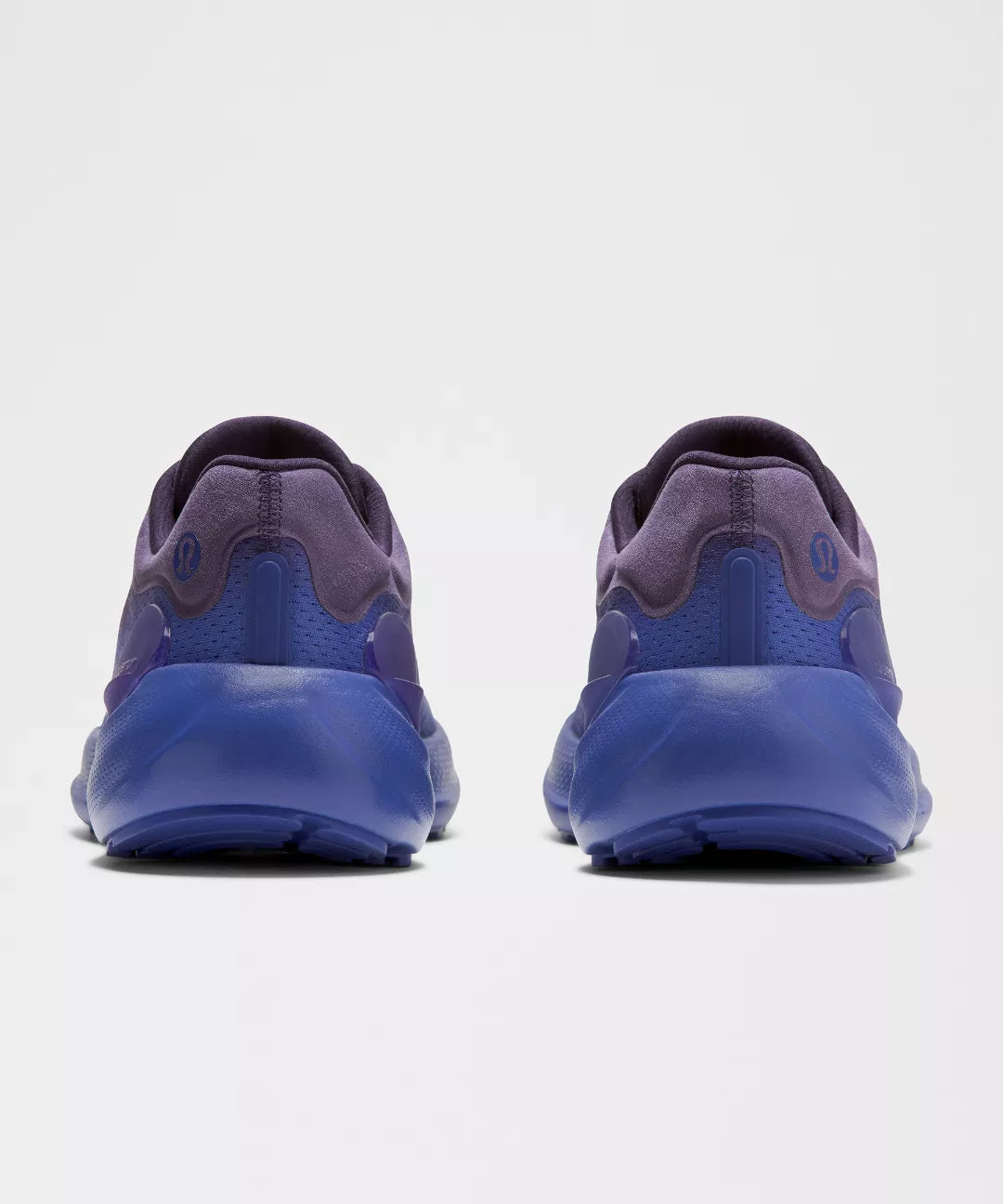 Blue athletic shoes shown from the back on a white background