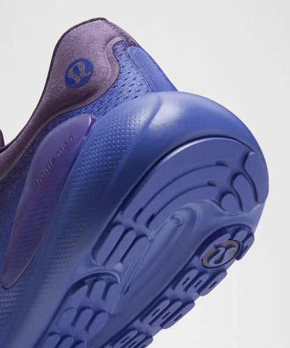 Close-up of a blue athletic shoe sole on a light gray background