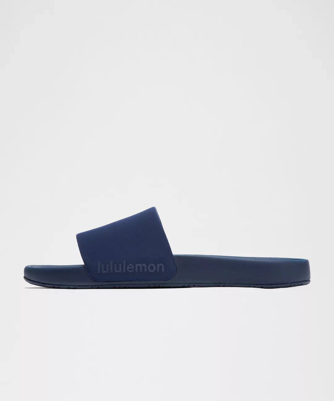 Navy blue slide sandal with 'lululemon' branding on a light gray background