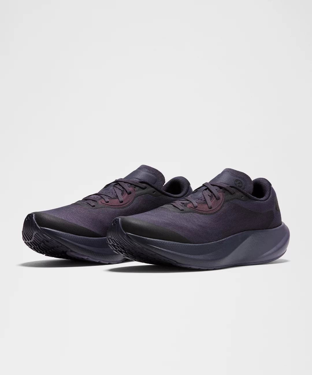 Pair of dark gray athletic shoes on a light gray background