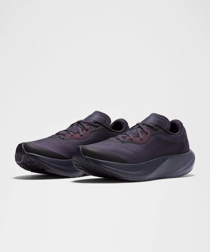 Pair of dark gray athletic shoes on a light gray background