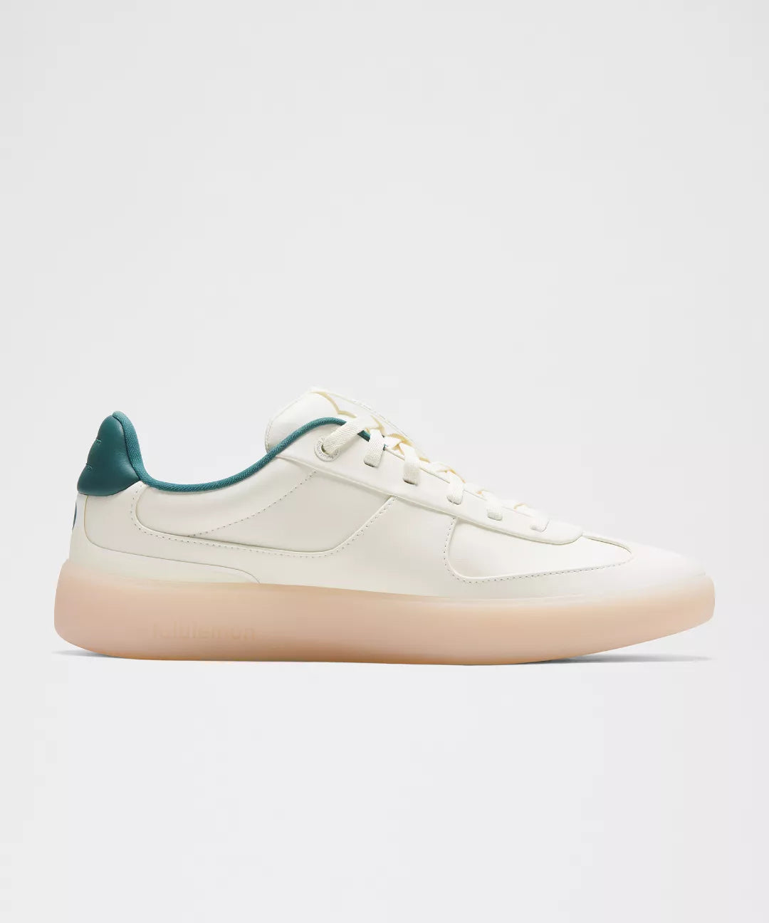 White sneaker with green accents on a light gray background