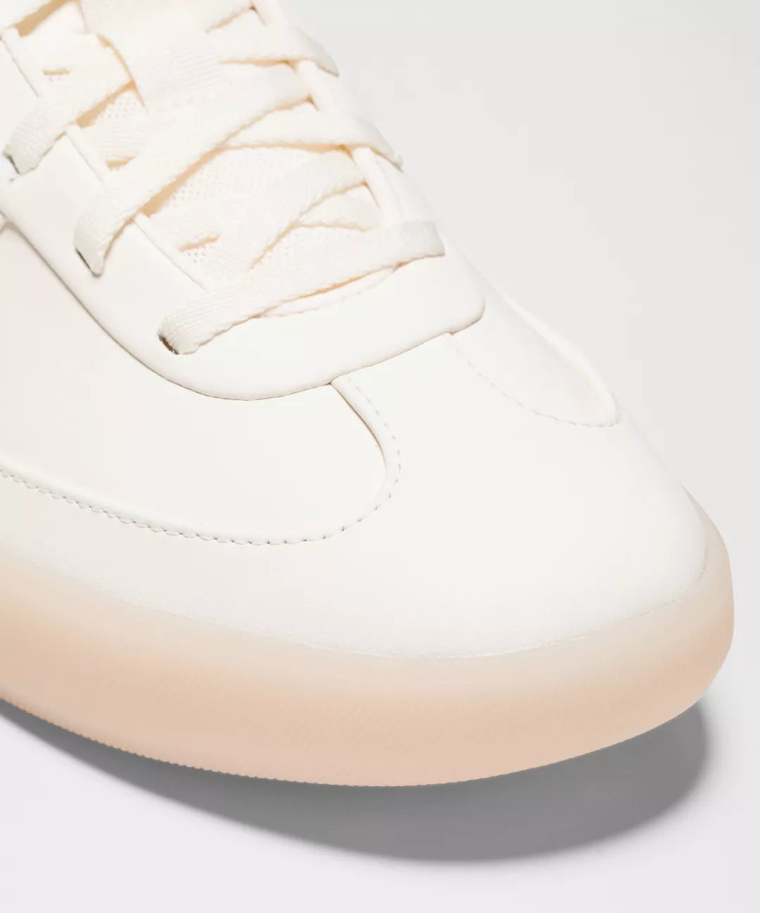 Close-up of a white sneaker on a light gray background