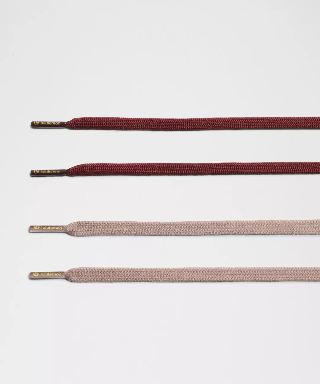 Set of brown and beige shoelaces on a light gray background